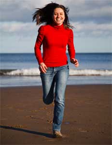 Healthy Woman Running on Beach